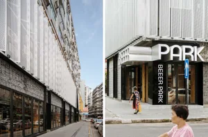 A modern building with metal cladding and a textured facade viewed from a street-level perspective.