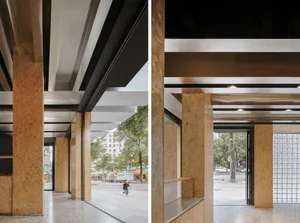 Modern exhibition space with wooden, concrete, and black metal architectural elements.