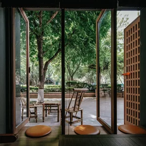 A view of a coffee shop featuring bamboo furniture and seating.