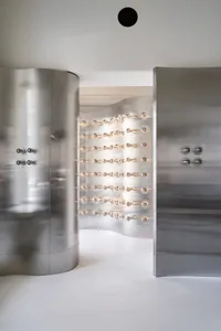 Minimalist interior with metallic aluminum walls and light bulbs on the wall