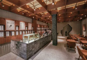 Interior design of a modern coffee shop featuring wood and marble materials.