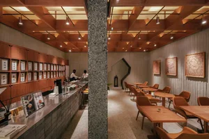 Modern restaurant interior with concrete and wood elements