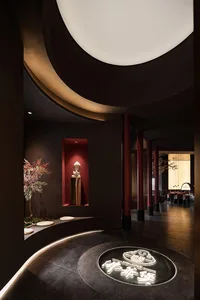 A modern dark-themed restaurant interior with wooden accents and marble flooring.