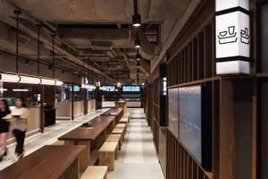 Industrial-themed restaurant interior with wooden tables and minimalist design