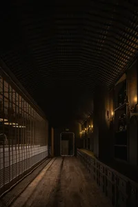 A minimalist corridor with metal and wooden elements.