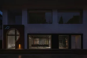 Minimalist storefront with glass windows at night