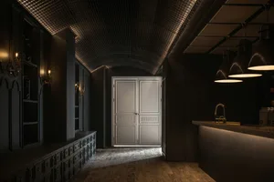 A modern bar with metallic glass bar counter and lighting fixtures.