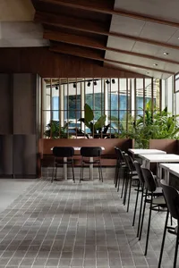 A modern cafe interior featuring wooden and concrete elements.