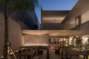 An image of a modern restaurant interior featuring concrete and wood materials.