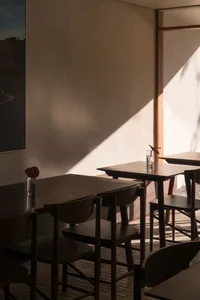 Modern restaurant interior with wooden furniture and minimalist design.