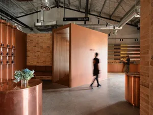 A modern retail storefront with brick walls, concrete flooring, and copper accents.