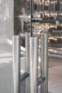 Close-up view of modern storefront entrance with vertical metal columns and glass panels.