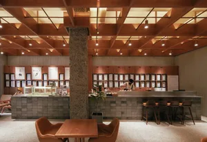 Industrial-style restaurant interior with metal counter and wooden furniture