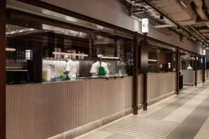 A modern commercial kitchen with a glass counter.