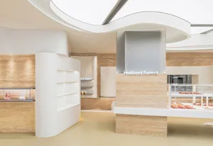 A modern, minimalist retail shop with white marble walls and floors.
