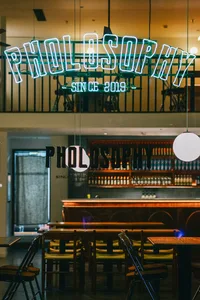 Industrial-themed restaurant interior with metal and glass signage.