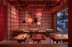 A cozy Japanese restaurant interior featuring wooden furniture and decor.