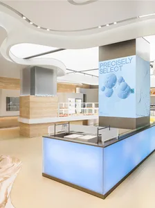 A sleek, modern bakery counter featuring illuminated lighting and light-colored materials.