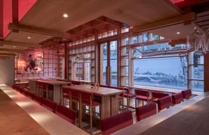 A modern cafe interior featuring wooden furniture and a flowery background