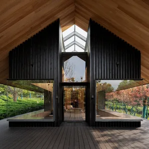 Modern residential interior featuring wood elements and large glass windows.