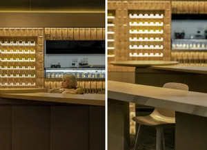 A modern restaurant interior featuring a bar counter with acrylic lighting.