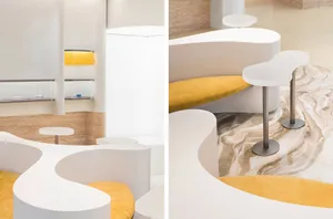 The image showcases a modern restaurant interior with a marble countertop and seating area.