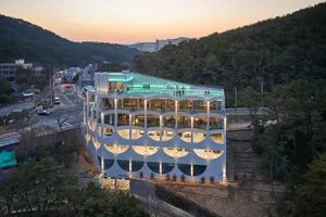 A modern office building with large glass windows and a concrete exterior.