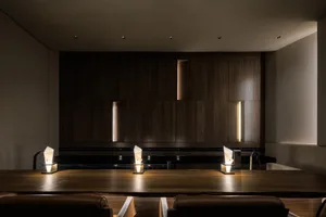 A modern restaurant bar interior with wooden furniture and ambient lighting
