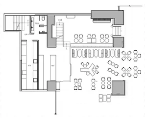 2D architectural drawing of a restaurant interior layout with various seating arrangements, a kitchen area, and functional zo
