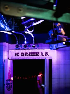 Metallic storefront in a dimly lit urban alleyway with industrial design elements.