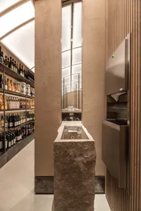 A modern retail store with concrete walls and a glass ceiling.