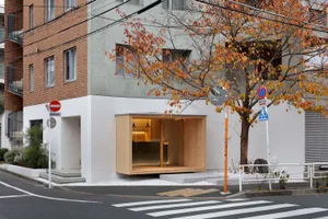 A modern exterior building with wooden accents and a concrete structure.