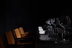 Empty minimalist restaurant interior with clear wine glasses.