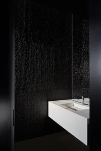 Minimalist bathroom with a concrete wall and white sink.