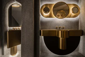 Modern bathroom interior with metallic sinks and lighting