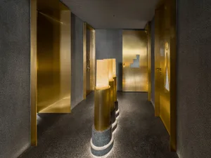 Modern office interior with industrial design features, including metal-clad walls and concrete flooring.