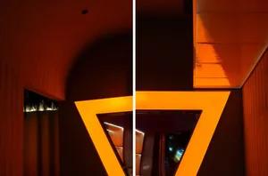 Architectural interior design featuring a modern triangular lighting feature.