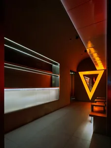 A modern restaurant interior featuring glass and metallic elements.