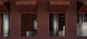 A modern wine cellar with metallic shelving units against a brick wall.