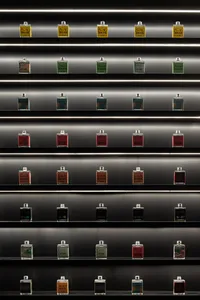A row of metallic bottles arranged on multiple shelves.