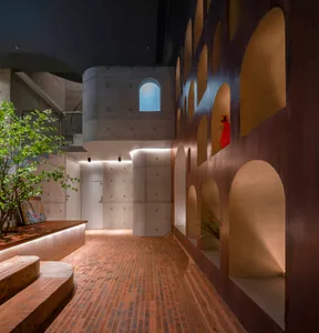 A minimalist interior with a combination of concrete and brick materials.