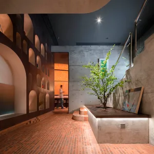 A modern architectural space featuring brick and concrete materials.