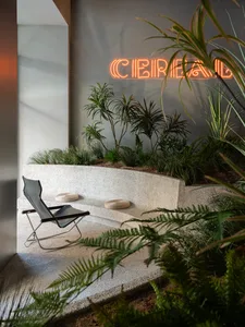 A modern leisure space featuring concrete flooring and seating.