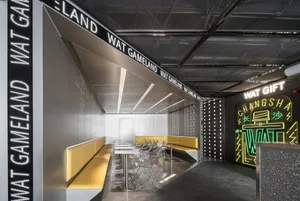 Modern restaurant interior with metallic and yellow elements