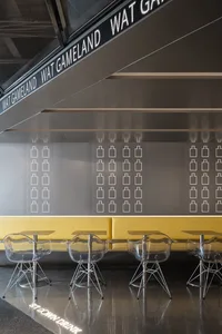 Interior of a modern cafe with metallic furniture and dark ambient lighting.