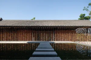 Minimalist wooden structure with water reflection, creating a serene and modern public art installation.
