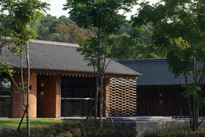 A modern building exterior made of brick, concrete, and wood.