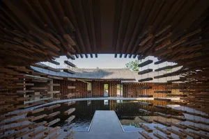 A modern interior space featuring wooden paneling and a large pool.