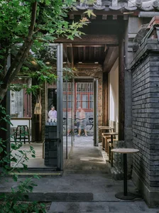 A modern coffee shop with brick exterior and glass doors.