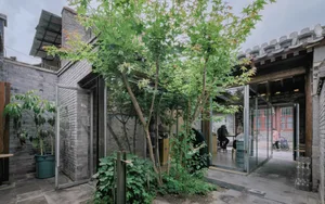 A modern coffee shop with brick exterior, glass doors, and concrete accents.